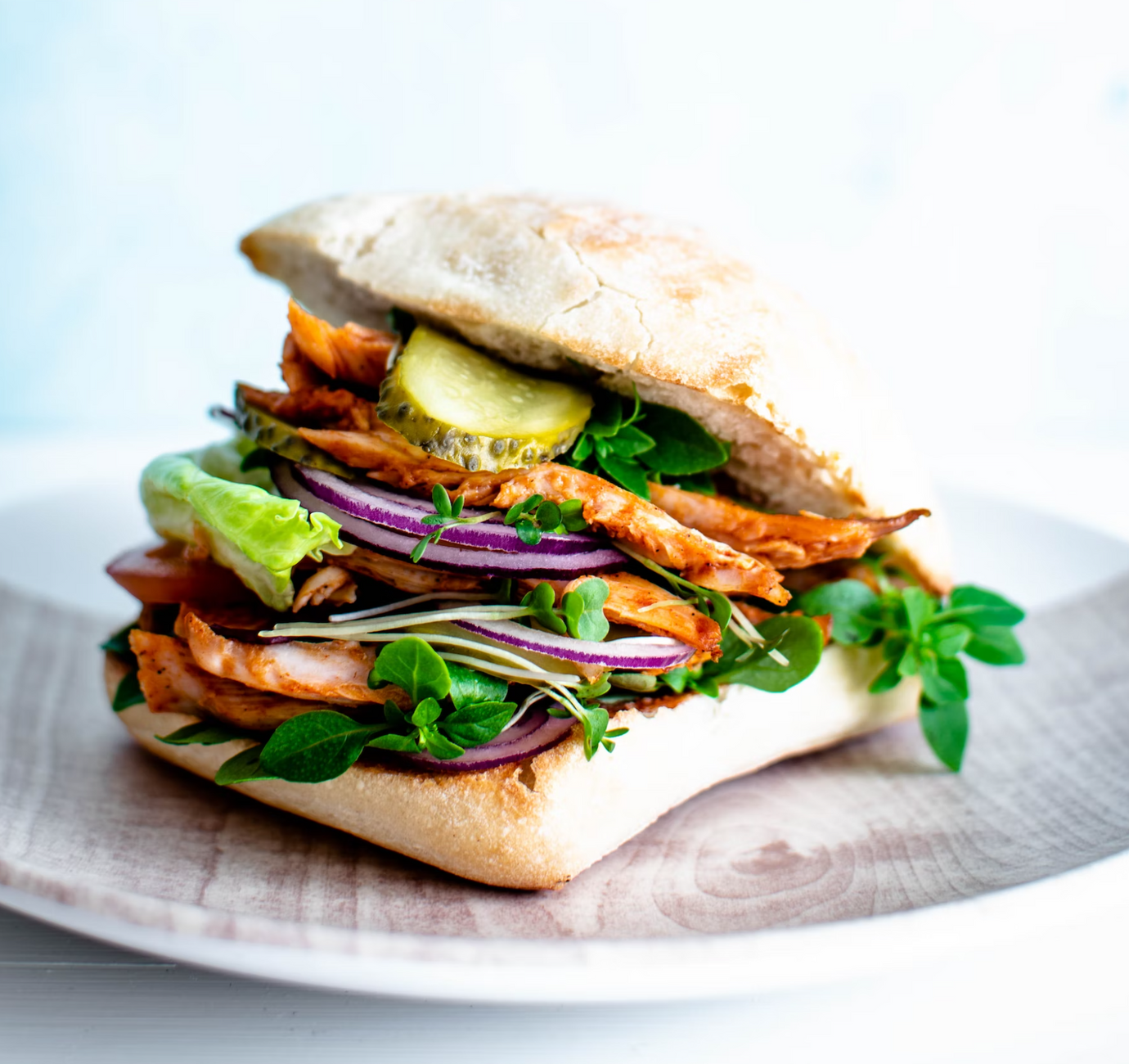 A chicken sandwich with vegetables