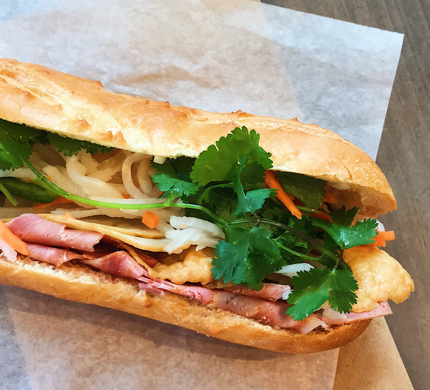 A vietnamese sandwich with lots of cilantro 