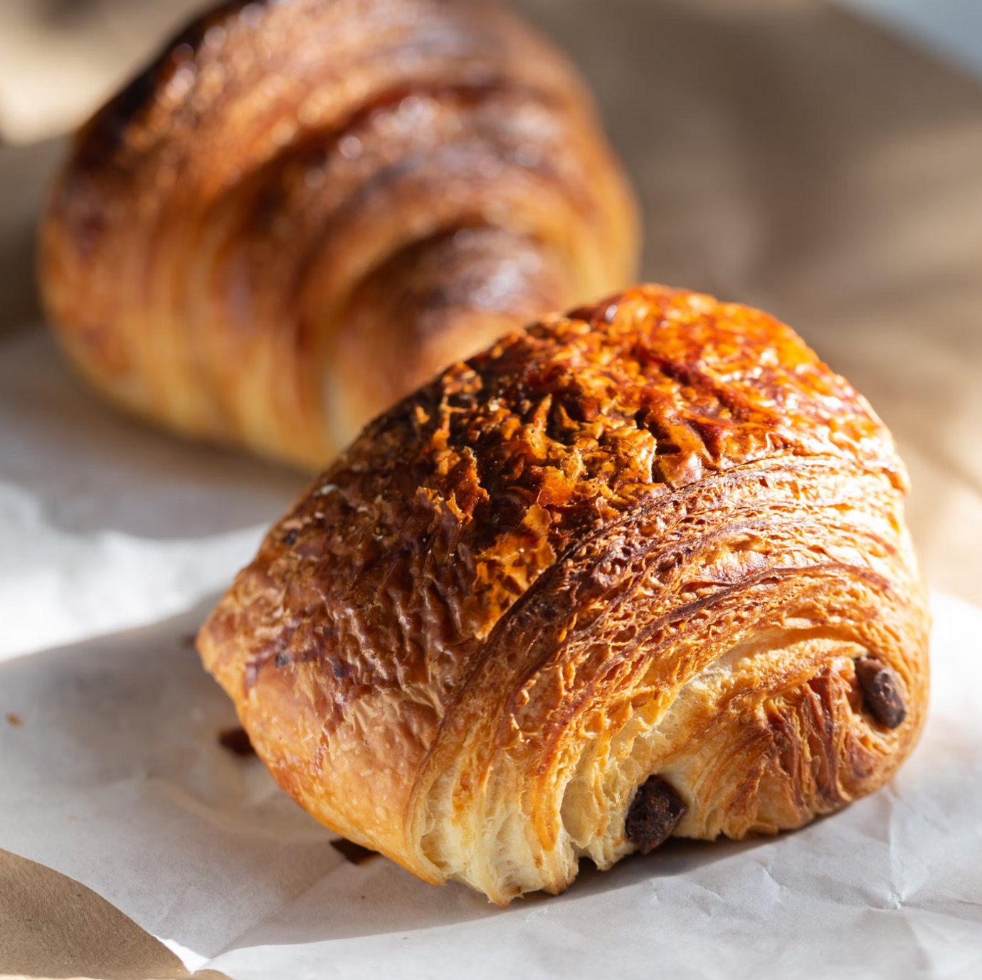Two chocolate pastries on a white paper
